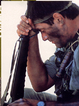 Knox sitting with head bowed with m60.gif (96637 bytes)